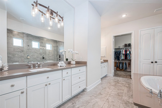 bathroom with vanity and a tile shower