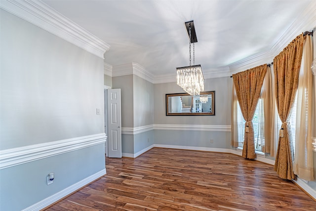 unfurnished dining area featuring dark wood-type flooring, a notable chandelier, and ornamental molding