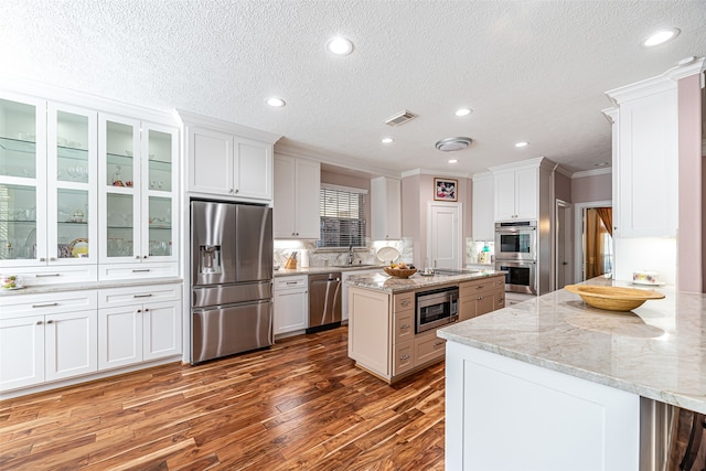 kitchen featuring dark wood-type flooring, appliances with stainless steel finishes, and white cabinets