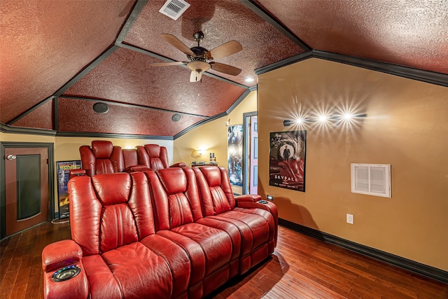 home theater featuring hardwood / wood-style floors, a textured ceiling, and vaulted ceiling