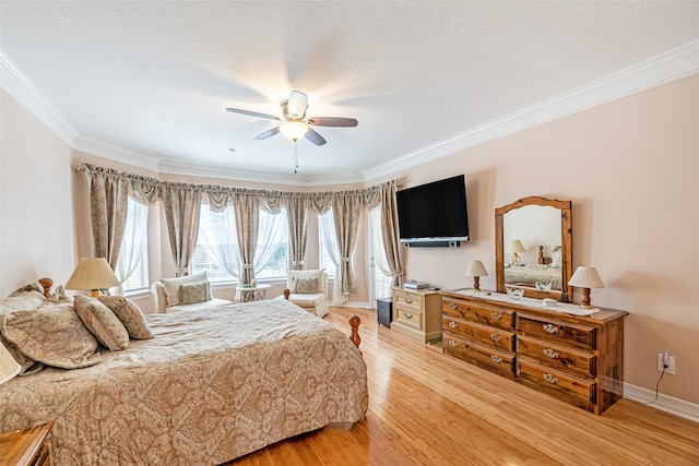 bedroom featuring ornamental molding, a textured ceiling, wood-type flooring, and ceiling fan