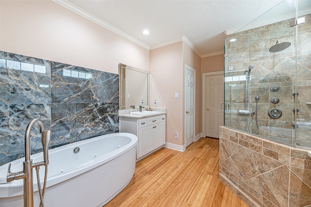 bathroom featuring hardwood / wood-style flooring, vanity, separate shower and tub, and crown molding