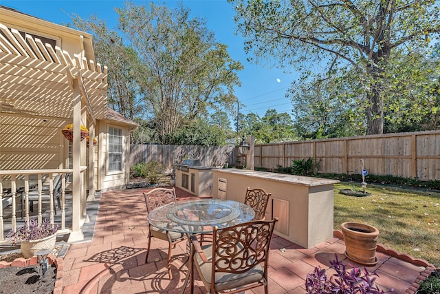 view of patio with a pergola and area for grilling