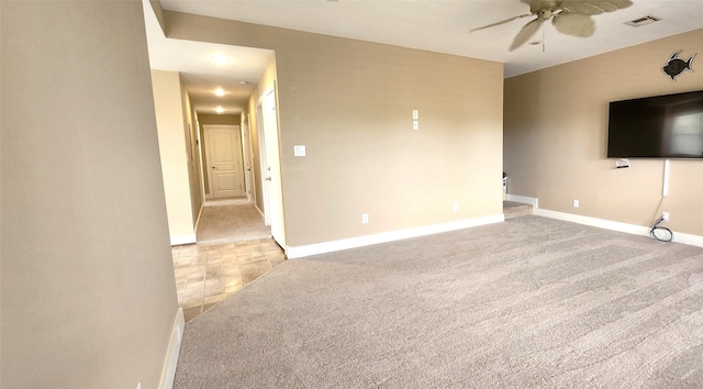 unfurnished living room featuring light carpet and ceiling fan