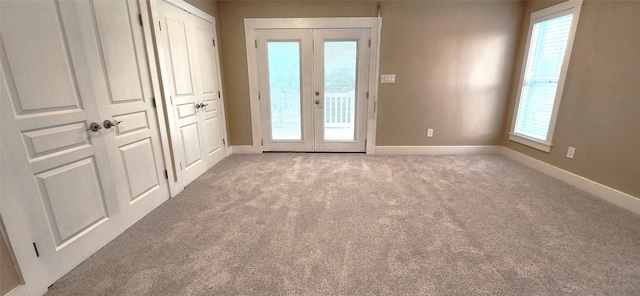 doorway with french doors and light carpet