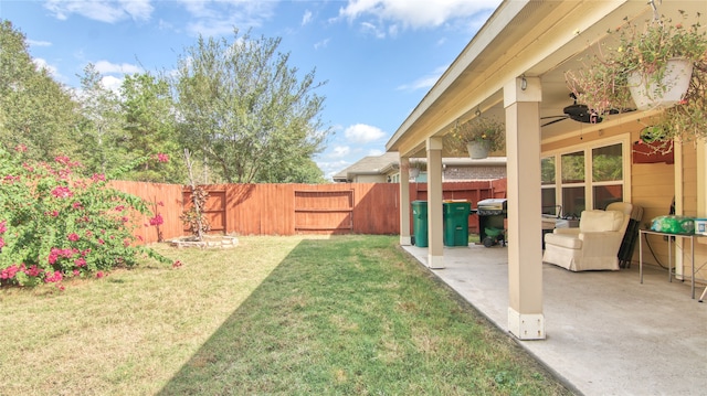 view of yard with a patio and ceiling fan