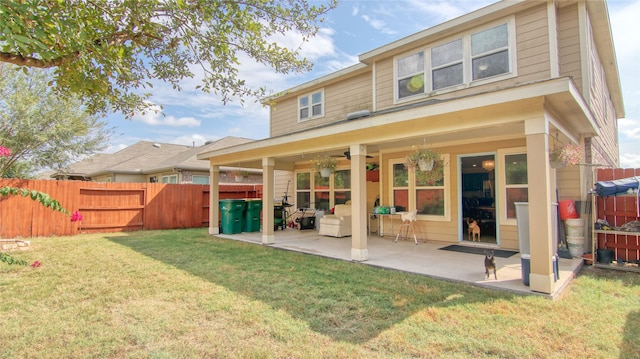 back of house featuring a yard, a patio, and ceiling fan