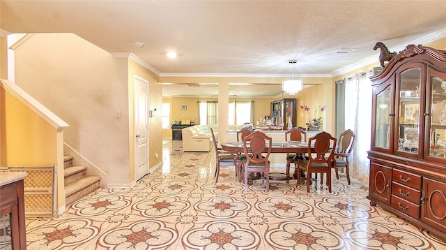 dining room with crown molding, a notable chandelier, and a textured ceiling