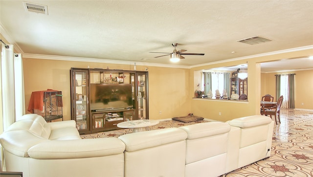 living room with crown molding, a textured ceiling, and ceiling fan