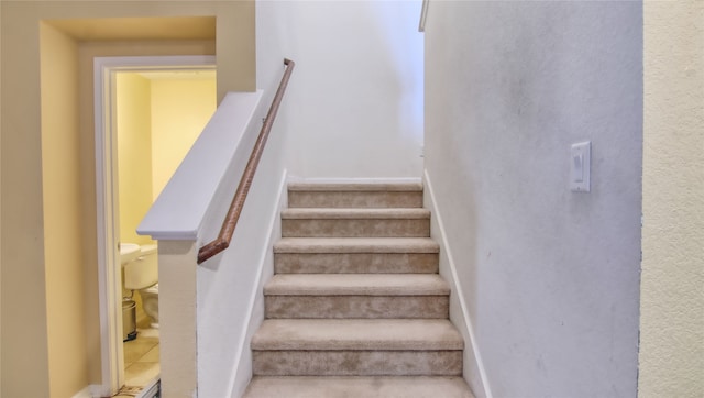 stairs featuring tile patterned flooring