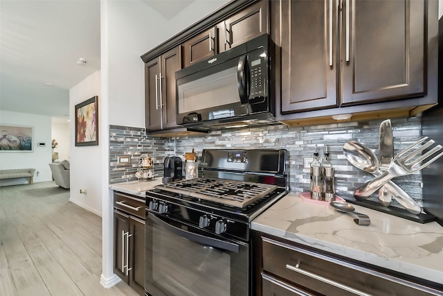 kitchen with black appliances, light stone counters, backsplash, dark brown cabinets, and light hardwood / wood-style flooring