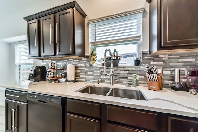 kitchen featuring black dishwasher, plenty of natural light, sink, and tasteful backsplash