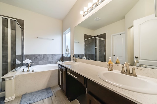 bathroom featuring hardwood / wood-style flooring, vanity, shower with separate bathtub, and lofted ceiling