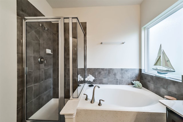 bathroom featuring vanity and separate shower and tub