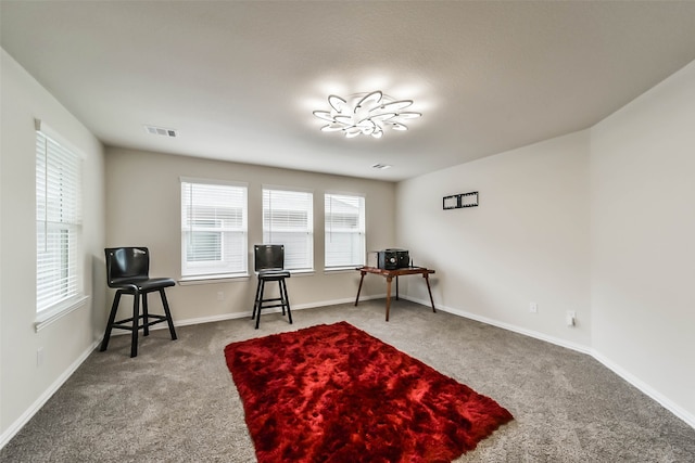 sitting room with carpet flooring and a healthy amount of sunlight