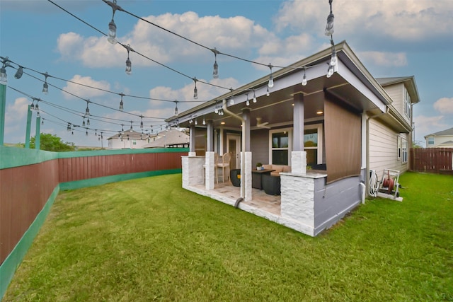 back of house with a patio and a yard