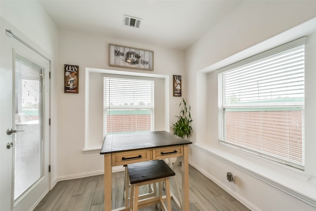 dining room featuring plenty of natural light and light hardwood / wood-style flooring