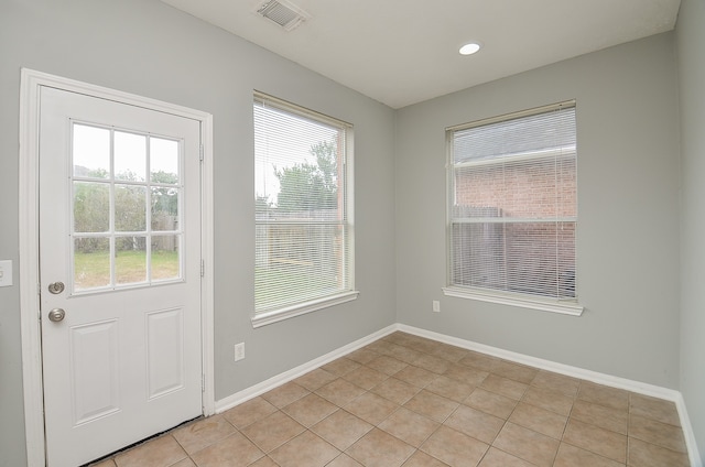 doorway to outside featuring light tile patterned floors