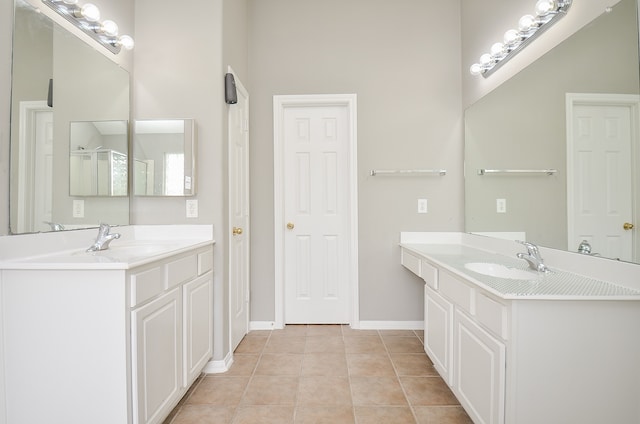 bathroom with a towering ceiling, tile patterned flooring, and vanity