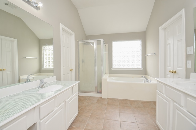 bathroom featuring tile patterned flooring, lofted ceiling, vanity, and independent shower and bath