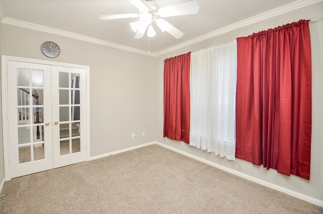 carpeted spare room featuring french doors, ceiling fan, and crown molding