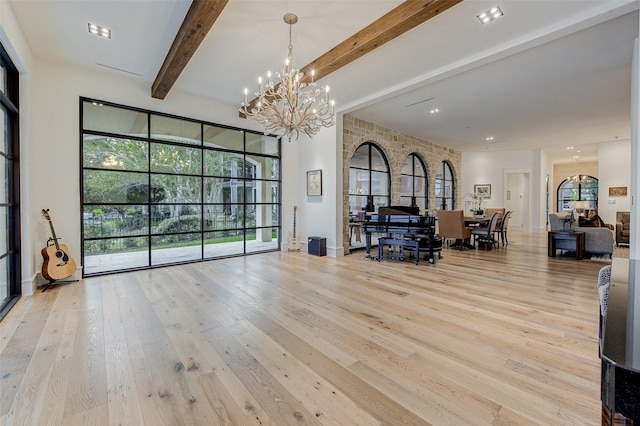 interior space featuring a notable chandelier, beam ceiling, and light wood-type flooring