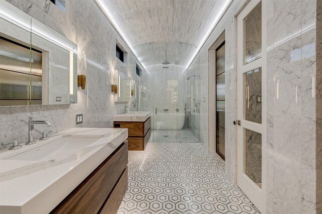 bathroom featuring vanity, tile walls, and separate shower and tub