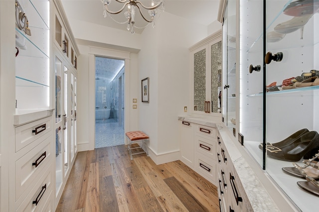 interior space with light hardwood / wood-style floors and a chandelier