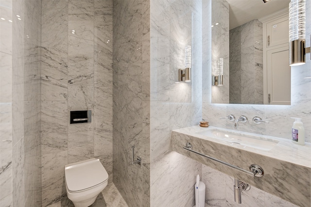 bathroom with vanity, toilet, and tile walls