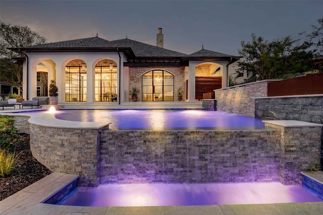 exterior space with a patio and pool water feature