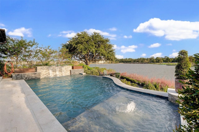 view of pool with pool water feature and a water view