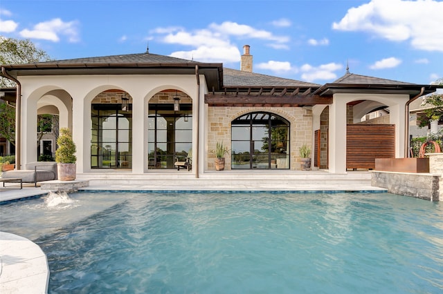 view of pool with a patio and pool water feature