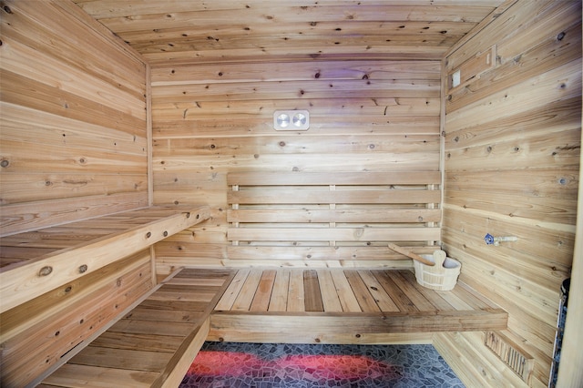 view of sauna with wood walls and wooden ceiling