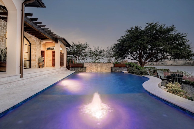 pool at dusk with a patio