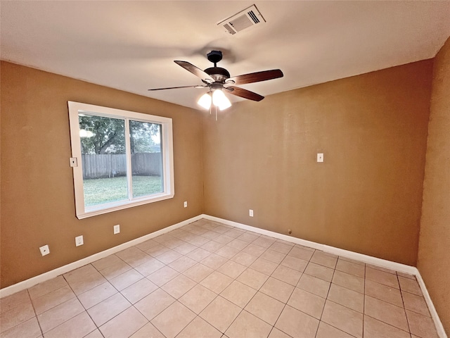 unfurnished room featuring ceiling fan and light tile patterned floors