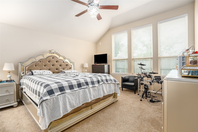 carpeted bedroom with ceiling fan and vaulted ceiling