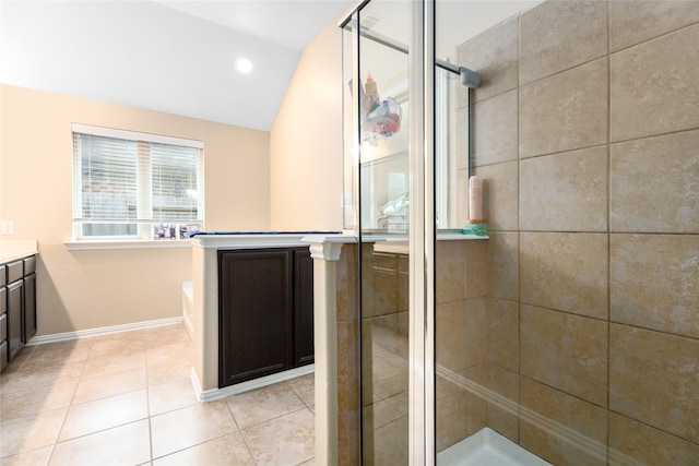 bathroom featuring vanity, lofted ceiling, separate shower and tub, and tile patterned flooring