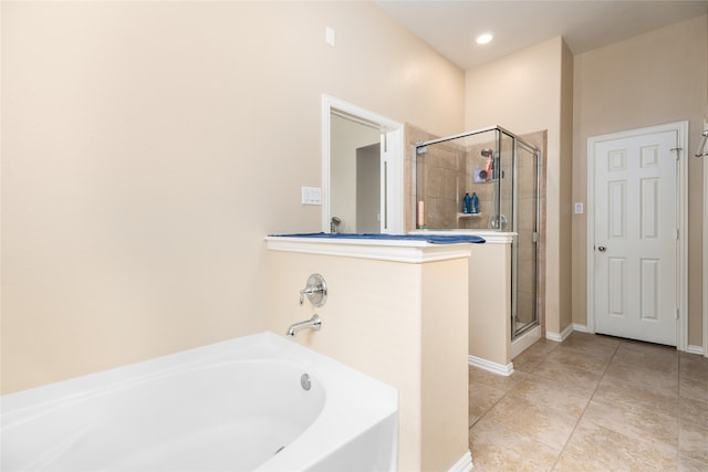 bathroom with independent shower and bath and tile patterned floors