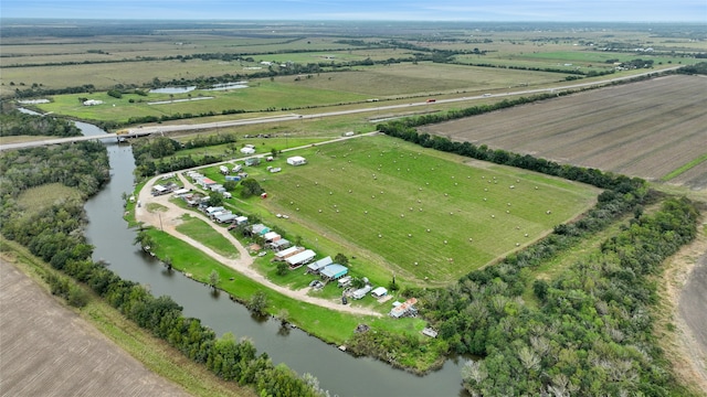 birds eye view of property with a water view and a rural view