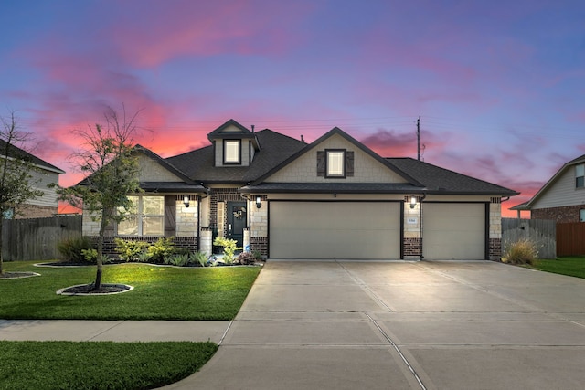 view of front of property with a lawn and a garage