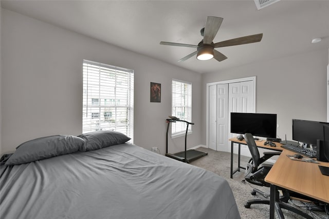 bedroom with light colored carpet, a closet, and ceiling fan