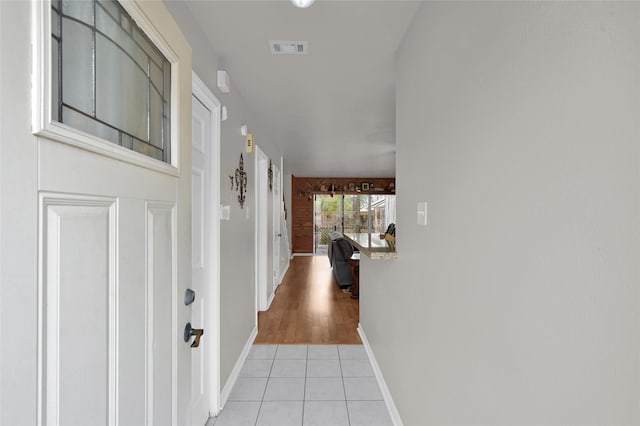 hall featuring light tile patterned floors