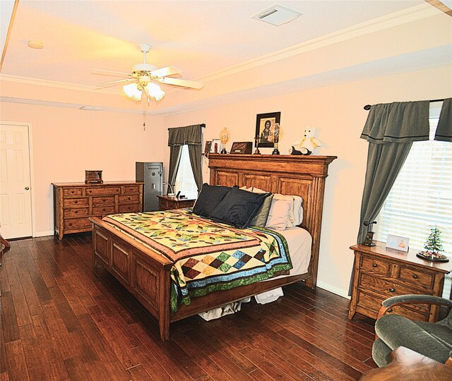 bedroom featuring dark wood-type flooring, ceiling fan, and ornamental molding