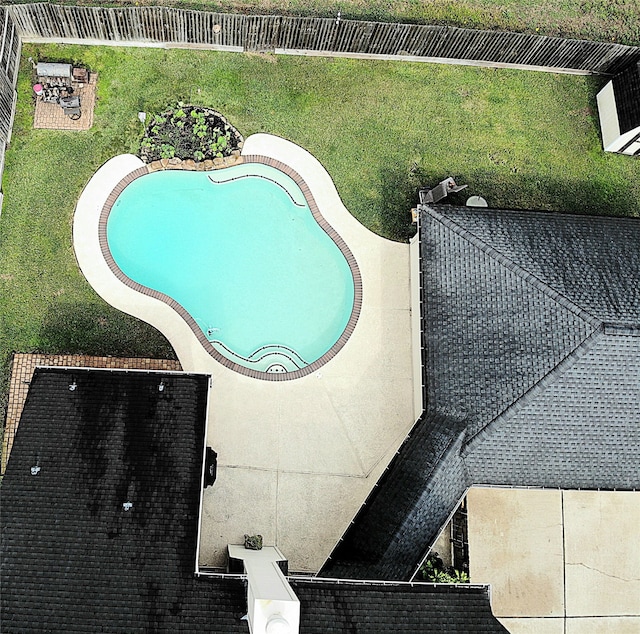 view of swimming pool featuring a lawn and a patio area