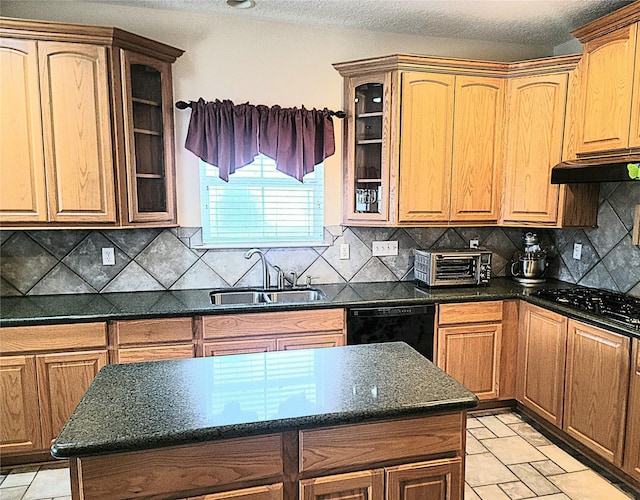 kitchen with a sink, a toaster, black appliances, glass insert cabinets, and under cabinet range hood