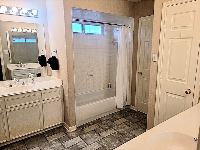 bathroom with shower / tub combo and vanity