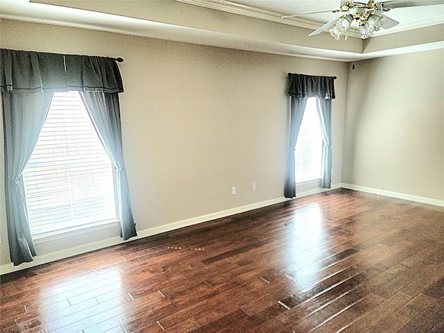 empty room with baseboards, ceiling fan, ornamental molding, and hardwood / wood-style floors