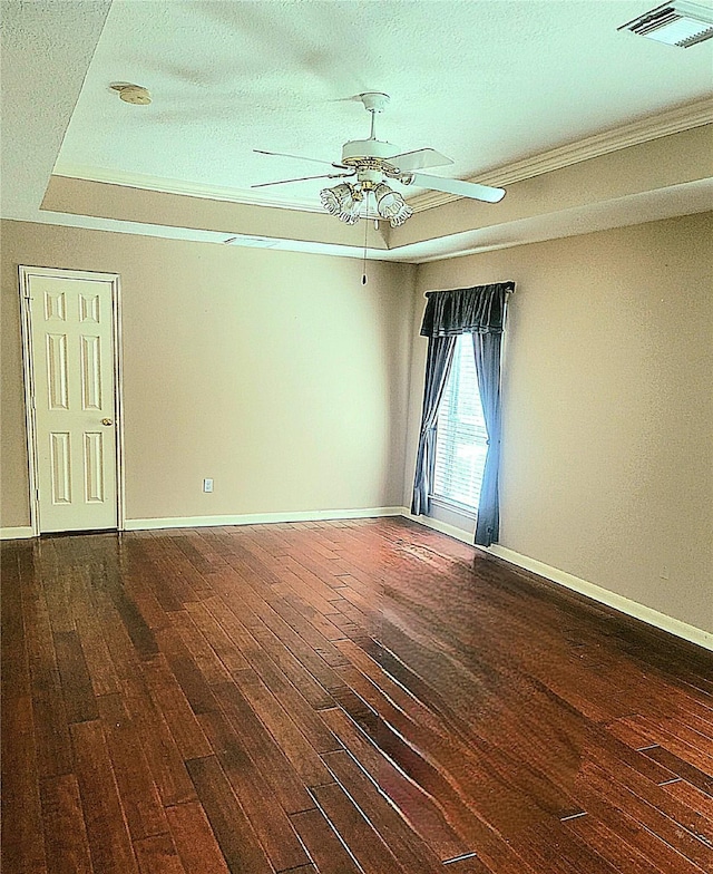 unfurnished room featuring ceiling fan, a textured ceiling, visible vents, dark wood finished floors, and baseboards