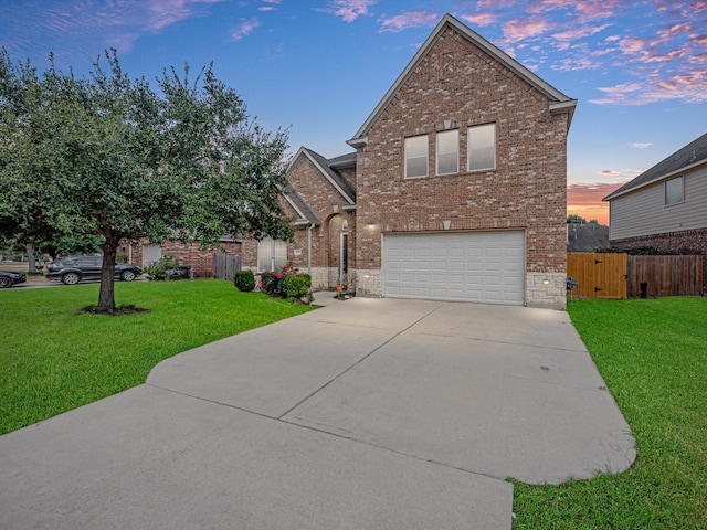 view of front property featuring a lawn and a garage