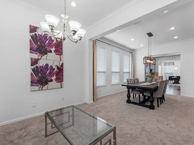 dining area with ornamental molding, carpet, and a chandelier